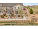 Inviting townhome with manicured landscaping, complemented by a white fence and a lush green space at 22898 E Ottawa Pl, Aurora, CO 80016
