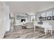 Bright living room with wood floors, complemented by modern décor, artwork, and natural light at 22898 E Ottawa Pl, Aurora, CO 80016