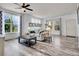 Comfortable living room with large windows, stylish curtains, and a neutral-toned sofa at 22898 E Ottawa Pl, Aurora, CO 80016