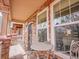 Cozy front porch with brick accents, showcasing a charming seating area and a view of the neighborhood at 22898 E Ottawa Pl, Aurora, CO 80016