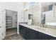 Modern bathroom featuring double sinks and a glass-enclosed shower, offering style and functionality at 5876 Alton St, Denver, CO 80238