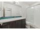 Bathroom featuring a modern vanity with a tile backsplash and a glass-enclosed shower at 5876 Alton St, Denver, CO 80238