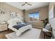 Cozy bedroom with modern light fixtures, a ceiling fan, and a bright window at 5876 Alton St, Denver, CO 80238