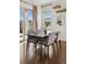 Dining room with wood floors, a sliding glass door, and decorative shelves and mirror at 5876 Alton St, Denver, CO 80238
