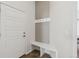 A well-organized entryway features a built-in bench and coat hooks, maximizing space and functionality at 5876 Alton St, Denver, CO 80238