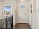 Bright foyer with hardwood floors, a white front door, and staircase at 5876 Alton St, Denver, CO 80238