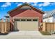 Attached two-car garage with a concrete driveway, offering convenience and curb appeal at 5876 Alton St, Denver, CO 80238