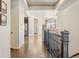 Upstairs hallway with hardwood floors and access to rooms at 5876 Alton St, Denver, CO 80238