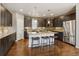 Well-lit kitchen with a central island, stainless steel appliances, and ample cabinet space at 5876 Alton St, Denver, CO 80238