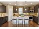 Contemporary kitchen with central island, stainless steel appliances, and dark cabinetry at 5876 Alton St, Denver, CO 80238
