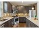 Modern kitchen with stainless steel appliances, wooden cabinets, and stylish backsplash at 5876 Alton St, Denver, CO 80238