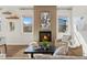 Beautiful living room with a modern fireplace, neutral colors, and natural light at 5876 Alton St, Denver, CO 80238