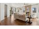 Open-concept living room with hardwood floors, a fireplace, and a view of the backyard at 5876 Alton St, Denver, CO 80238