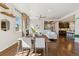 Open-concept living space with fireplace, hardwood floors, and a seamless flow to the kitchen at 5876 Alton St, Denver, CO 80238