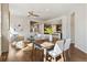 Open-concept living area with hardwood floors, dining area, and view to the kitchen at 5876 Alton St, Denver, CO 80238