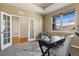 Bright office space with french doors, carpet, and a desk with a large window at 5876 Alton St, Denver, CO 80238
