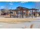 A wooden pergola structure is in the middle of a grassy field at 5876 Alton St, Denver, CO 80238