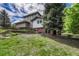 House back view with stone wall and landscaping at 9535 S Shadow Hill Cir, Lone Tree, CO 80124
