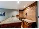 Basement bar area boasts a granite countertop, sink, and custom cabinetry for entertaining at 25257 Snyder Ave, Conifer, CO 80433