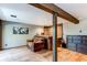 The basement offers a comfortable seating area, a wet bar, and rustic wood accents throughout at 25257 Snyder Ave, Conifer, CO 80433