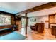 Spacious basement with hardwood floors, exposed brick, and a convenient exercise area with weights at 25257 Snyder Ave, Conifer, CO 80433