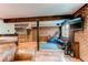 Well-lit basement features exposed brick, an exercise area, and an open layout for versatile use at 25257 Snyder Ave, Conifer, CO 80433