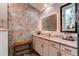 Stylish bathroom with an illuminated mirror, decorative tile, and a modern vanity at 25257 Snyder Ave, Conifer, CO 80433