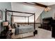Spacious bedroom with a four-poster bed, chandelier, and cozy decor at 25257 Snyder Ave, Conifer, CO 80433