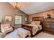 Charming bedroom with a wooden bed frame, fur accents, and an antler chandelier at 25257 Snyder Ave, Conifer, CO 80433