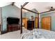 Bedroom featuring a four-poster bed, wood accents, and ample storage at 25257 Snyder Ave, Conifer, CO 80433