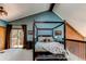 Bedroom with a four-poster bed, wood beams, and a balcony overlooking nature at 25257 Snyder Ave, Conifer, CO 80433