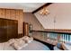 Upper level bedroom featuring wood beams, a cozy armchair, and a unique chandelier at 25257 Snyder Ave, Conifer, CO 80433