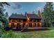 Spacious exterior with large deck and seating surrounded by trees at 25257 Snyder Ave, Conifer, CO 80433