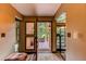 View of foyer to exterior deck with seating; interior includes area rug and hall with light fixtures at 25257 Snyder Ave, Conifer, CO 80433