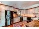 Well-lit kitchen features stainless steel appliances, wood floors, custom cabinets, and neutral countertops at 25257 Snyder Ave, Conifer, CO 80433