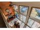 Overhead view of a cozy living room with a brick fireplace and expansive windows at 25257 Snyder Ave, Conifer, CO 80433