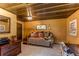 Inviting living room with daybed, wood ceiling, and charming decor; perfect for relaxation and guests at 25257 Snyder Ave, Conifer, CO 80433