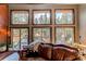 Bright living room boasts a wall of windows offering scenic views and natural light at 25257 Snyder Ave, Conifer, CO 80433