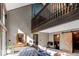Inviting living room with vaulted ceilings, wood accents, and a cozy sliding barn door at 25257 Snyder Ave, Conifer, CO 80433