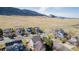 Panoramic aerial view of a neighborhood nestled against a scenic mountain range under a partly cloudy sky at 9640 S Johnson St, Littleton, CO 80127