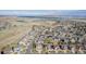 Expansive aerial shot of a residential community featuring diverse homes and a large lake in the background at 9640 S Johnson St, Littleton, CO 80127