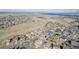 High-angle aerial view showing houses and a lake in the distance at 9640 S Johnson St, Littleton, CO 80127