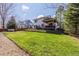 Large, well-maintained backyard with a grassy lawn and a partially covered deck area at 9640 S Johnson St, Littleton, CO 80127