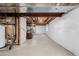 Spacious unfinished basement with exposed pipes, white plastic on walls, and a seating area at 9640 S Johnson St, Littleton, CO 80127