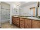 Bright bathroom with double sink vanity, granite countertops, and a shower-tub combo at 9640 S Johnson St, Littleton, CO 80127
