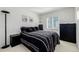 Cozy bedroom featuring modern decor, a window for natural light, and a black-and-white theme at 9640 S Johnson St, Littleton, CO 80127