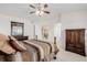 Spacious bedroom featuring neutral decor, carpet, and dark wood furniture at 9640 S Johnson St, Littleton, CO 80127