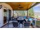 Covered outdoor deck with comfortable seating, a fire pit, and a scenic view at 9640 S Johnson St, Littleton, CO 80127