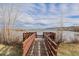 Scenic boardwalk leading to a tranquil lake with mountain views in the distance at 9640 S Johnson St, Littleton, CO 80127