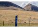 Equestrian trail in a field with mountains, power lines, and blue sky at 9640 S Johnson St, Littleton, CO 80127